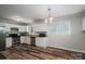 Bright kitchen features stainless steel appliances, granite countertops, white cabinets, and wood-look flooring at 108 Graham St, Stanley, NC 28164