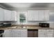 Spacious kitchen with stainless steel appliances, granite countertops, and bright white cabinets at 108 Graham St, Stanley, NC 28164