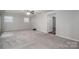 Large living room offers neutral carpet, ceiling fan, and plenty of natural light at 108 Graham St, Stanley, NC 28164