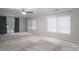 Spacious living room features neutral carpet, ceiling fan, and lots of natural light at 108 Graham St, Stanley, NC 28164