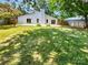 Large back yard is fenced and features mature trees, a patio, and plenty of space to play at 10934 Coachman Cir, Charlotte, NC 28277