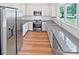 Modern kitchen features stainless steel appliances, stone countertops, and white cabinets at 10934 Coachman Cir, Charlotte, NC 28277