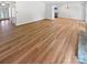 Open-concept living room with wood flooring, neutral paint, and modern lighting at 10934 Coachman Cir, Charlotte, NC 28277