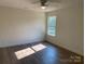 A spacious bedroom with wood-look flooring and a bright window at 1103 Adams St, Statesville, NC 28677