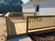 Close-up of a newly built wooden deck with a railing, perfect for outdoor relaxation at 1103 Adams St, Statesville, NC 28677