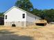 Exterior view of a white home with a walkout basement and a wooden deck at 1103 Adams St, Statesville, NC 28677