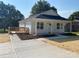 Charming home featuring a neatly landscaped yard, a cozy porch, and a freshly paved driveway at 1103 Adams St, Statesville, NC 28677