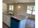 Spacious kitchen island featuring a double sink and elegant countertops in a well-lit home at 1103 Adams St, Statesville, NC 28677