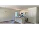 Bright kitchen with island, stainless appliances, white cabinetry, and wood-look flooring at 1103 Adams St, Statesville, NC 28677