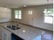 Modern kitchen island with granite countertops, stainless steel sink, and sleek fixtures at 1103 Adams St, Statesville, NC 28677