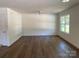 Open living room with bright window and wood-look floors at 1103 Adams St, Statesville, NC 28677