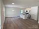 Open-concept living space featuring hardwood floors, natural light, and a modern kitchen at 1103 Adams St, Statesville, NC 28677
