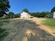 Expansive backyard featuring lush greenery and the rear exterior of the charming home at 1103 Adams St, Statesville, NC 28677