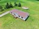 Aerial view of a well-maintained single-Gathering home with a metal roof, set on a lush green lawn at 1133 Lynn Ln, Catawba, NC 28609