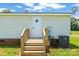 Back entrance to home with wooden stairs and porch with a white door at 1133 Lynn Ln, Catawba, NC 28609