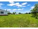 Spacious backyard featuring a large grassy area with home and additional shed at 1133 Lynn Ln, Catawba, NC 28609