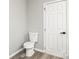 Modern bathroom featuring a toilet, door with black handle, and neutral color scheme at 1133 Lynn Ln, Catawba, NC 28609