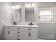 Bright bathroom with double vanity, stylish mirrors, and a window offering natural light at 1133 Lynn Ln, Catawba, NC 28609