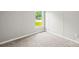 View of a bedroom with a window, showing light carpet, and a neutral color scheme at 1133 Lynn Ln, Catawba, NC 28609