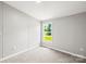 A cozy bedroom is shown featuring neutral walls, carpet, and a window view at 1133 Lynn Ln, Catawba, NC 28609