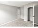 A modern bedroom with gray carpet, showing the doorway leading to an adjacent closet at 1133 Lynn Ln, Catawba, NC 28609