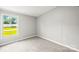 A bright bedroom with a window allowing natural light to illuminate the gray carpet at 1133 Lynn Ln, Catawba, NC 28609