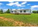 Front exterior view of a single-story home with a metal roof and large yard at 1133 Lynn Ln, Catawba, NC 28609