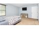 Bright bedroom showcasing a twin bed, window, and storage cabinets for a cozy retreat at 1288 Century Dr, Clover, SC 29710