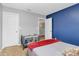 Stylish bedroom with a blue accent wall, modern crib, and cozy bedding for a peaceful rest at 1288 Century Dr, Clover, SC 29710
