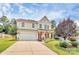 Charming two-story home featuring a manicured lawn, inviting front porch, and a driveway at 1288 Century Dr, Clover, SC 29710