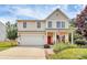 Charming two-story home with a manicured lawn, American flag, and a red front door at 1288 Century Dr, Clover, SC 29710