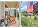 Cozy front porch featuring rocking chairs, a welcome lantern, and a view of a garden at 1288 Century Dr, Clover, SC 29710