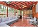 Inviting screened-in porch with ceiling fan, comfortable seating, and a built-in grill area at 1288 Century Dr, Clover, SC 29710