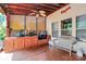 Charming covered porch with comfortable seating, a built-in grill area and backyard access at 1288 Century Dr, Clover, SC 29710