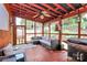 Relaxing screened-in porch with ceiling fan, comfortable seating, and a built-in grill area at 1288 Century Dr, Clover, SC 29710
