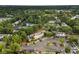 Overhead view of townhome community with mature trees, landscaping, ample parking, and green common areas at 12914 Sickles Dr, Charlotte, NC 28273