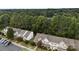 An aerial view of townhomes with plenty of trees and parking, with an abundance of green space at 12914 Sickles Dr, Charlotte, NC 28273