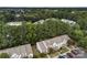 Aerial shot of townhome community featuring mature trees, parking spaces, landscaping and green common areas at 12914 Sickles Dr, Charlotte, NC 28273