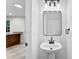 Well-lit modern bathroom with pedestal sink and open entrance at 12914 Sickles Dr, Charlotte, NC 28273