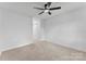 This spacious bedroom features neutral carpet and a ceiling fan at 12914 Sickles Dr, Charlotte, NC 28273