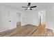 Bright bedroom featuring a ceiling fan and light wood-look flooring throughout at 12914 Sickles Dr, Charlotte, NC 28273