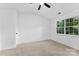 Bright bedroom featuring a window, ceiling fan, and neutral carpet at 12914 Sickles Dr, Charlotte, NC 28273