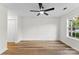 Spacious bedroom showcasing hardwood floors, natural light, and a ceiling fan at 12914 Sickles Dr, Charlotte, NC 28273