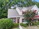 Charming townhouse with red brick accents, landscaped bushes, and a beautiful crape myrtle in full bloom at 12914 Sickles Dr, Charlotte, NC 28273