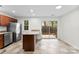 Eat-in kitchen with stainless steel appliances, granite counters, and a sliding door to the outside at 12914 Sickles Dr, Charlotte, NC 28273