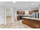 Kitchen view featuring granite counters, tiled floors, and stairway at 12914 Sickles Dr, Charlotte, NC 28273