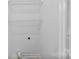 A bright, small laundry room with wire shelving for storage at 12914 Sickles Dr, Charlotte, NC 28273