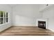 Bright living room featuring laminate wood flooring, a fireplace and a large window at 12914 Sickles Dr, Charlotte, NC 28273