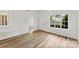 Sunlit living room boasting laminate wood flooring and a large window with a street view at 12914 Sickles Dr, Charlotte, NC 28273