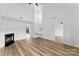 Spacious living room with soaring ceilings, a fireplace, stairs and light wood floors at 12914 Sickles Dr, Charlotte, NC 28273